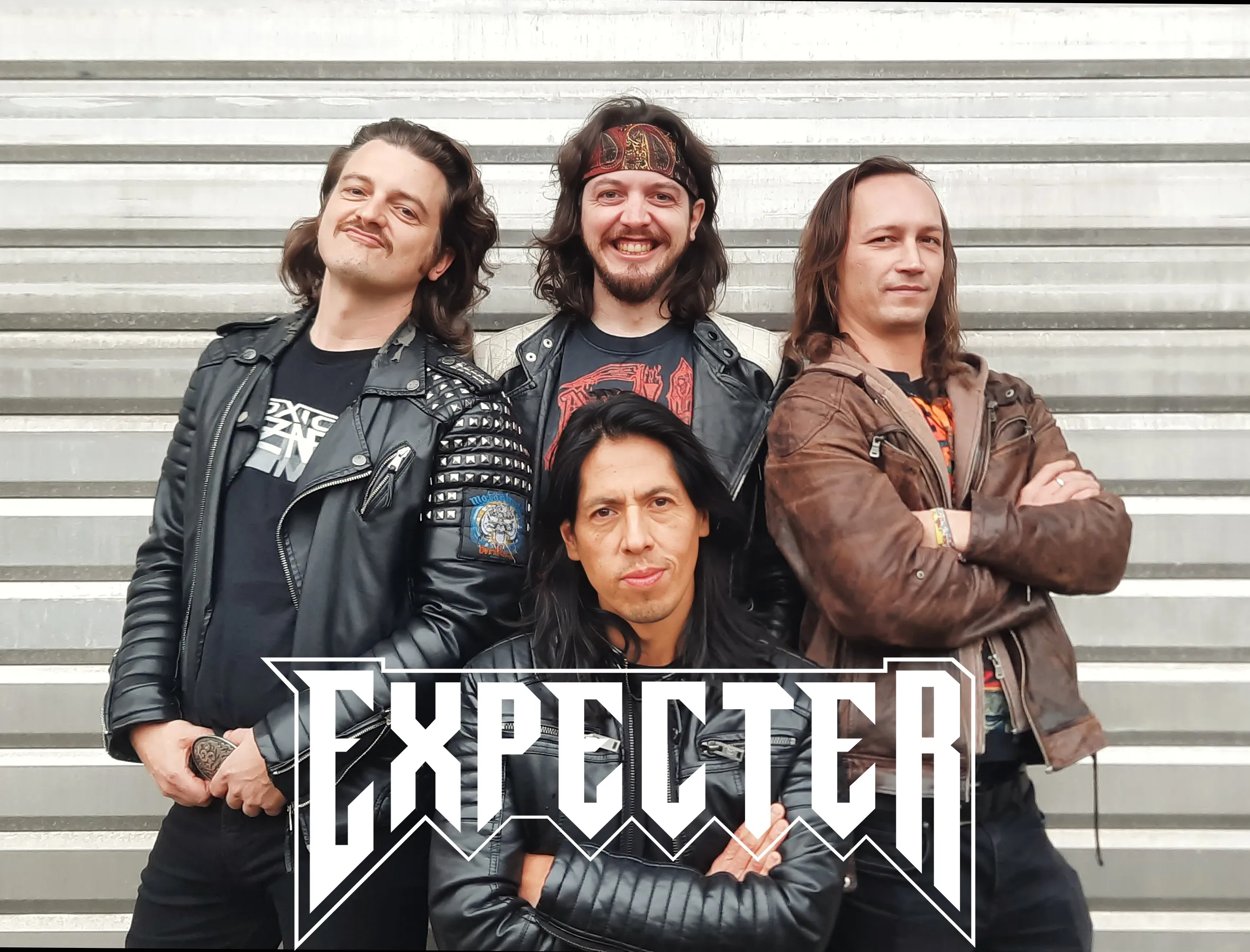 Vier Männer mit langen Haaren posieren für die Kamera. Unten im Bild ist ihr Logo "Expecter" zu sehen.